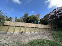 Retaining wall and fence above