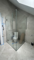 Corner shower shaped around shelf