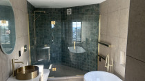 Inline shower using brushed brass hardware
