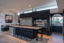 Kitchen island frame fabrication - We were privileged to craft the entire island base that supports the exceptional slab of marble - from the curved end detail on the left hand side, through to the custom powder-coated steel and stainless table legs at the other. This island is at the heart of the family kitchen, the result a solid foundation that lets the marble and design shine.