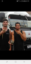 Jamie and conrad holding a clients pet lizzards