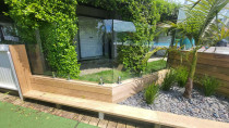 Plinth wall with glass - Bethel's beach farmstay job see through handrail continuous from pool to garden.
