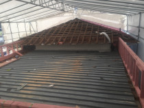 Roof upgrade and Reclad by Top 2 Bottom Carpentry Ltd - This property had 2 parts to the building, 1 part had a pitched tile roof and the other part was a flat roof made from iron long run.
So what we did is had an enclosed scaffolding built so that the weather couldn't hold us up. We then had all the existing Asbestos cladding professionally removed and disposed of, and build new raised walls on top of the existing walls, we then fitted a truss roof on top of the new walls and fitted new concrete roof tiles making both roofs look as one.
We then fitted new building wrap and cladding with new windows an doors to the walls.