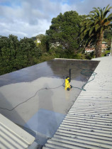 3. Roof Top Before - Right from the start - Waterblasting first to remove grime and ensure a clean surface before applying fibreglass aand Traffigard
Location: Lower Hutt