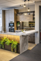 Innovative Kitchens - Mt Roskill Showroom - Floor to ceiling timber units matched with concrete colour engineered stone benchtops.