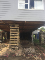 Basement conversion (Part 2) - Top 2 Bottom Carpentry Ltd had the Asbestos cladding professionally removed and disposed of, we then supported the house and removed all piles and bearers.
We excavated to dig into the sloping ground, and to form foundation trenches.