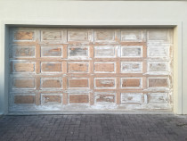 Garage door prepped ready for undercoating and final coats by H2GLO Services - Old paint stripped, garage door sanded. Repairs made to door. Loose rotten fibres removed, areas treated with Hardner and filled, sanded and shaped, sealed ready for top coating